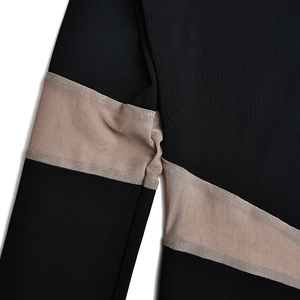 Detail of high-stretch bodysuit showing sheer beige mesh panel on black polyester fabric