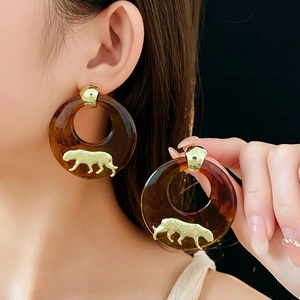 Amber resin hoop earrings featuring gold leopard relief studs for a stylish look