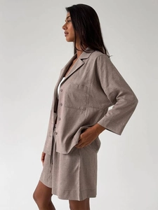 Detail of taupe casual linen set featuring button-up shirt with large utility pocket