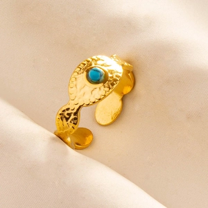 Macro shot of gold adjustable 304 stainless steel ring with blue turquoise and hammered texture