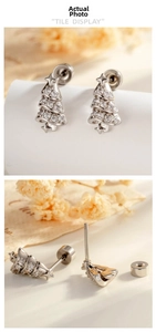 Detail of silver Christmas tree stud earrings with micro-set zircons and secure screw backs