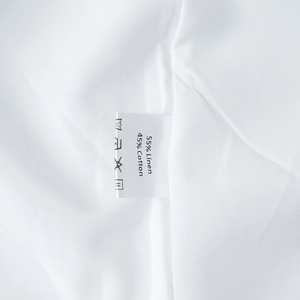 Detailed view of clothing label showing 55% linen and 45% cotton fabric composition