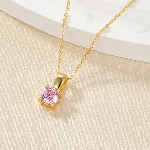 Macro view of 925 sterling silver gold plated necklace with a pink zircon pendant