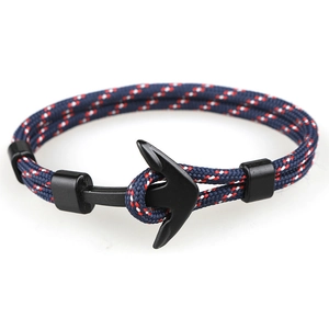 Detail of nautical anchor bracelet with blue, red, white paracord and matte black hook