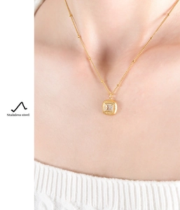 Detail of vintage gold square pendant necklace with clear zircon on stainless steel bead chain