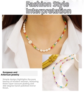 Detail of colorful beaded necklace with a white daisy pendant and baroque pearls