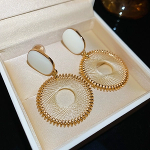 Detail of French style dreamcatcher earrings with gold woven circles in a jewelry box