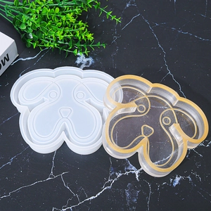 Detail of cartoon dog head silicone mold and finished gold-rimmed resin trinket tray