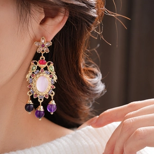 Macro shot of a vintage flower drop earring with colorful crystals and purple beads