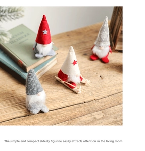 Set of four Nordic Christmas gnomes with knit hats and wooden skis on a wooden tabletop