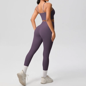 Detailed back view of purple yoga set featuring sleek cross-back bra and high-waist leggings