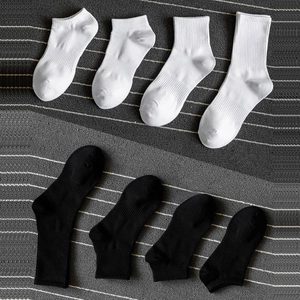 Set of black and white cotton sports socks in four different lengths for men and women