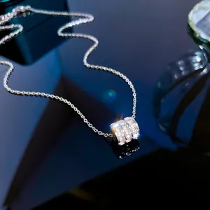 Close-up of minimalist titanium steel necklace with triple row crystal cylinder pendant