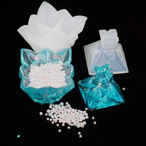 Detail of DIY resin mold showing lotus storage box with pearls and silicone tools