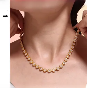 Close-up of gold-plated tennis necklace with pavé cubic zirconia on model neck
