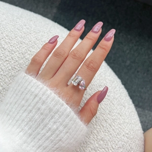Close-up of S925 silver ring featuring emerald-cut clear and pear-shaped pink stones