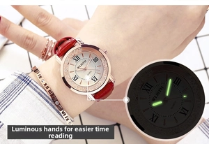 Close-up of women's quartz watch with red leather strap and luminous hands feature