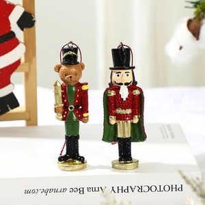 Detail of Christmas nutcracker resin hanging ornaments with red string and gold hardware