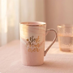Detail of pink marble ceramic mug with gold rim and Best Mom Ever lettering art
