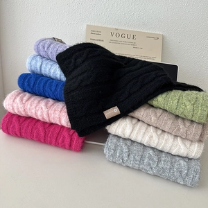 Macro shot of colorful knitted wool scarves showing soft texture and premium cable knit weave
