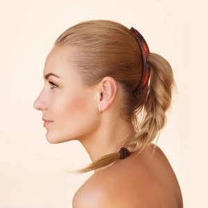 Detail of dark brown tortoiseshell banana hair clip on a blonde ponytail style