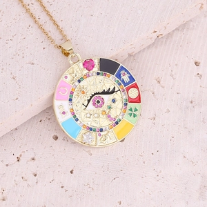 Detail of gold evil eye pendant necklace with colorful enamel and crystal accents