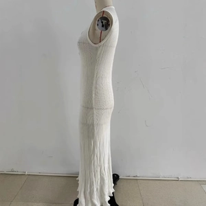 Slim fit sleeveless white knit maxi dress with a deep V-neck and elegant side profile