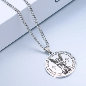 Detailed close-up of Archangel Michael round pendant with engraved names and Cuban chain