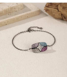 Detail of S925 silver bracelet with multicolor zircon stones and star pattern charm