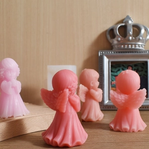 Pink angel shaped scented candles with intricate wing details for home decor