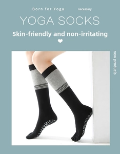 Close-up of non-slip grippers on over-the-knee yoga socks with five-toe design