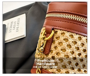Detail of woven straw texture and premium brown leather trim with gold metal hardware