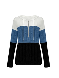 Detailed view of women's color-block hoodie with ribbed knit texture and half-zipper