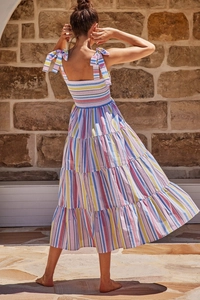 Detail of bohemian rainbow striped tiered dress with elastic back and ribbon tie straps