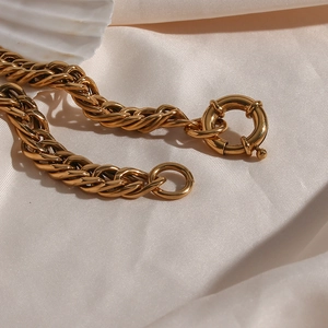 Detail of 18K gold plated thick chain necklace with round spring clasp on silk