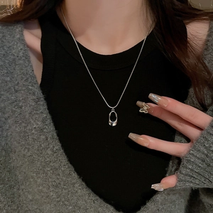 Minimalist silver stainless steel hollow oval necklace and butterfly ring worn by model