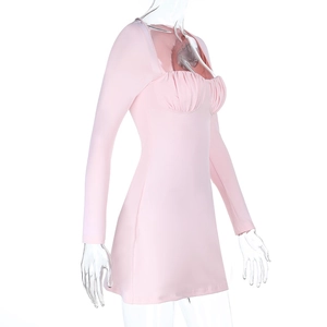 Detail of light pink mini dress showing ruched bust design and ribbed knit fabric texture
