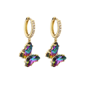 Macro detail of gold-plated crystal butterfly earrings with gradient stones and pavé crystals