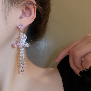 Close-up of pink zircon butterfly tassel earrings with cascading crystal drops
