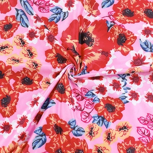 Detailed macro view of the floral print fabric with pink base and vibrant petal texture