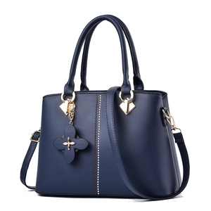 Classic navy blue faux leather handbag with metal studs and flower charm for women