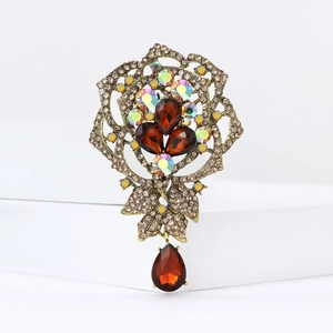 Macro view of vintage rose brooch featuring bronze metal and brown teardrop rhinestones