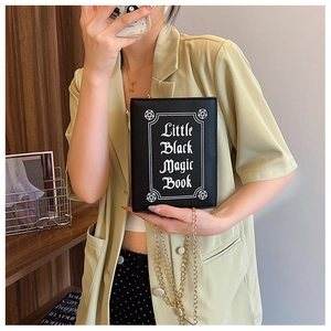 Detail of Little Black Magic Book gothic clutch bag with gold chain and white printing