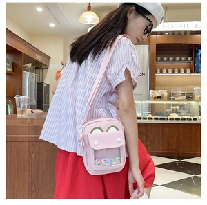 Detail of pink canvas ita bag with transparent display window and adjustable strap