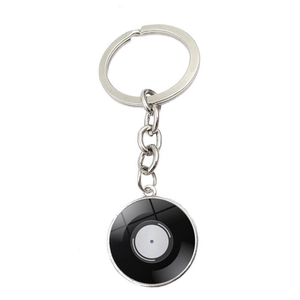 Detail of vintage vinyl record pattern inside glass cabochon with silver keychain