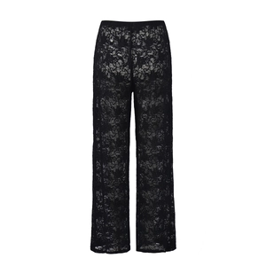 Detailed view of black lace wide-leg pants featuring intricate floral hollow-out patterns