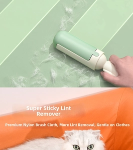Detail of mint green pet hair remover with nylon brush head for lint and cat fur
