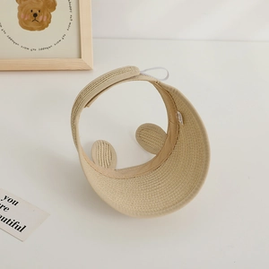 Detail view of beige straw visor with bear ears and adjustable velcro strap for kids