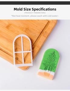 Detail of arched window cookie mold with a finished Christmas tree pattern biscuit