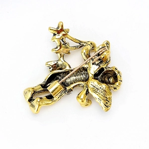 Vintage gouden engelbroche met sterpatronen en antieke metalen afwerking op wit